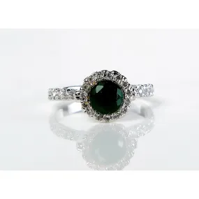 An alluring dark green emerald stone surrounded by small shiny diamonds (925 Sterling Silver)